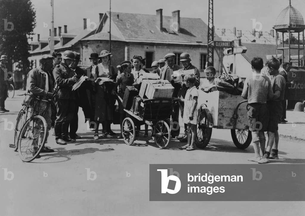 Refugees Returning To Their Homes In Occupied France A German Soldier 