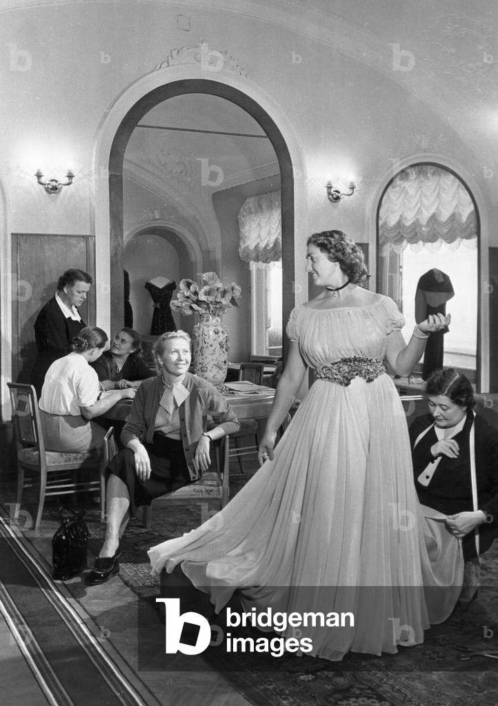 Una donna che prova su un vestito in un negozio di sartoria a Mosca, novembre 1955.