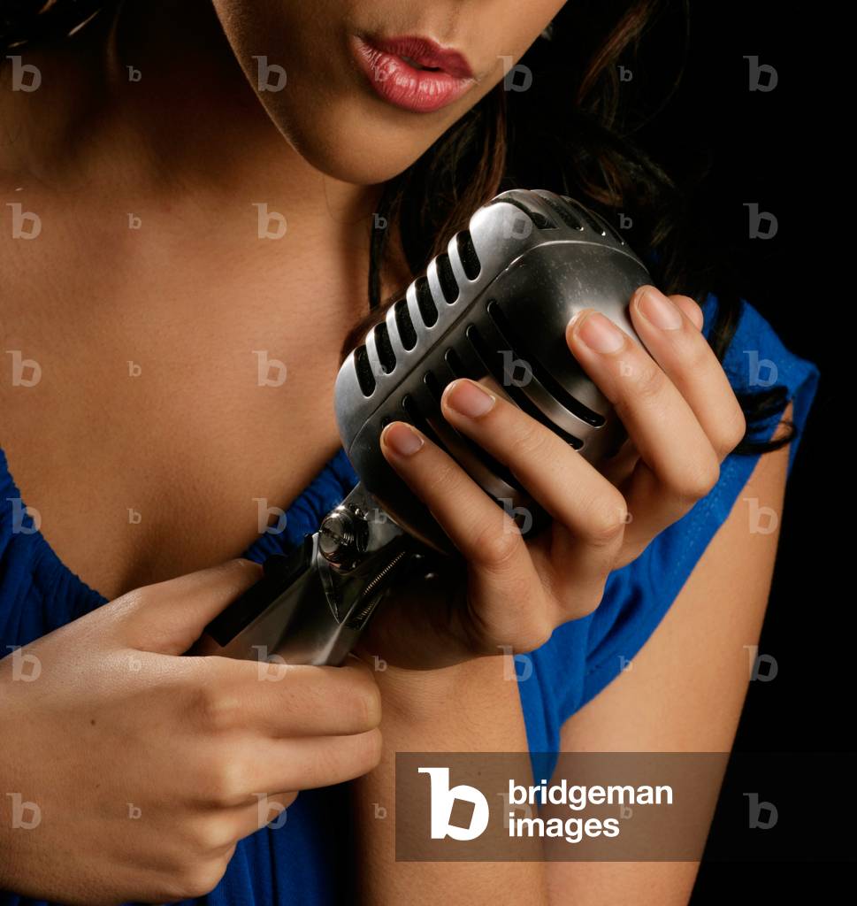 Image of Photography depicting Young woman singing into a microphone by Chris Stock