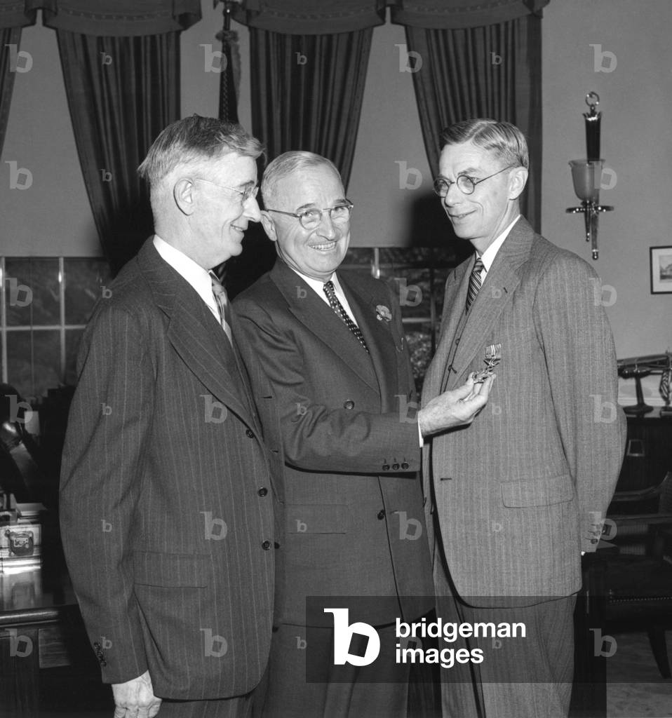 Image of President Harry Truman, center, presenting chemist Dr. James