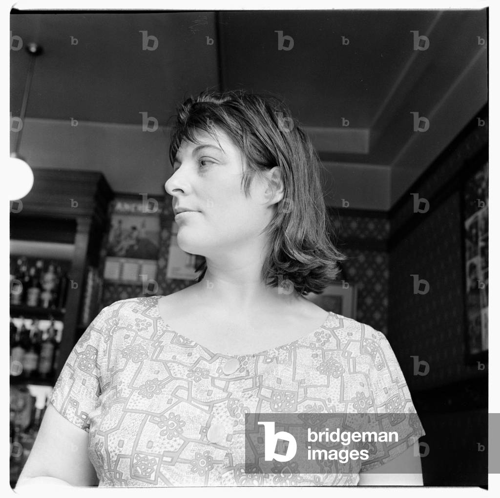 Henrietta Moraes, portrait of model and muse Henrietta Moraes in a bar, Soho London late 1950's (b/w photo)