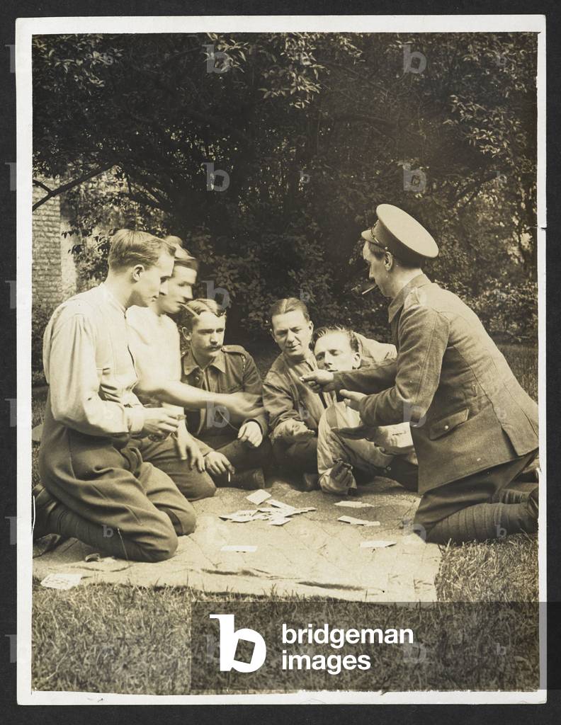 Image of British soldiers at play [France]. Soldiers playing cards. 1915.