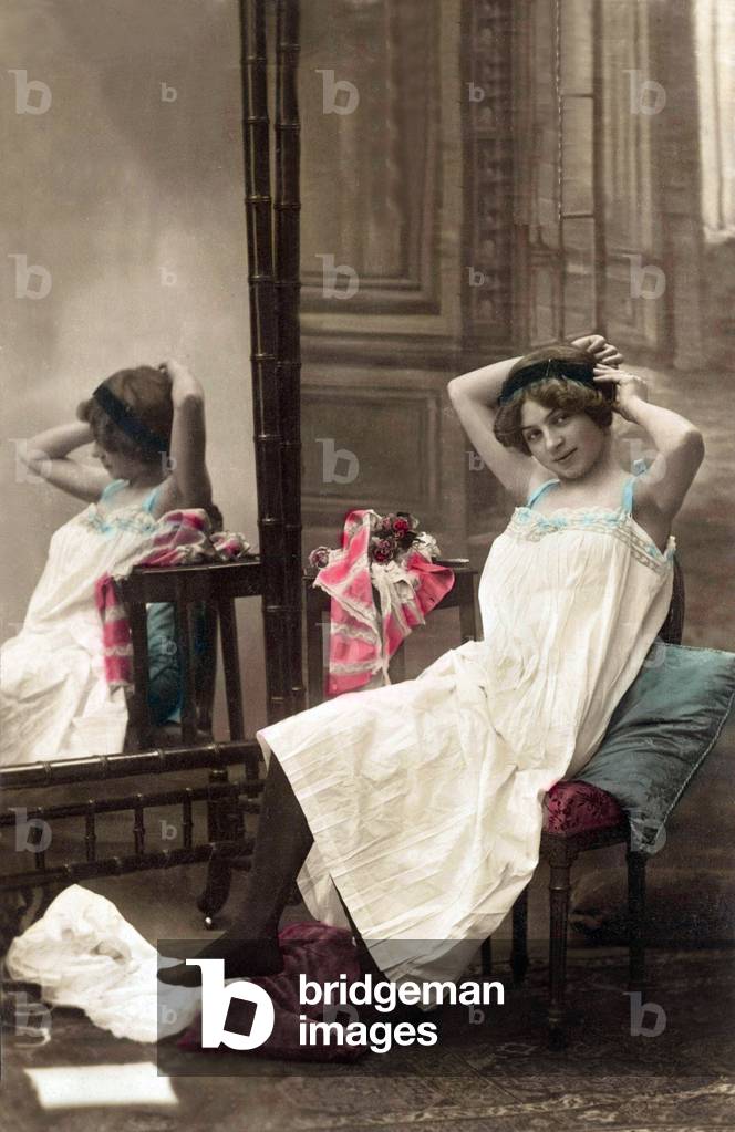 Image of Photography depicting Young woman in negligee near a mirror 1910