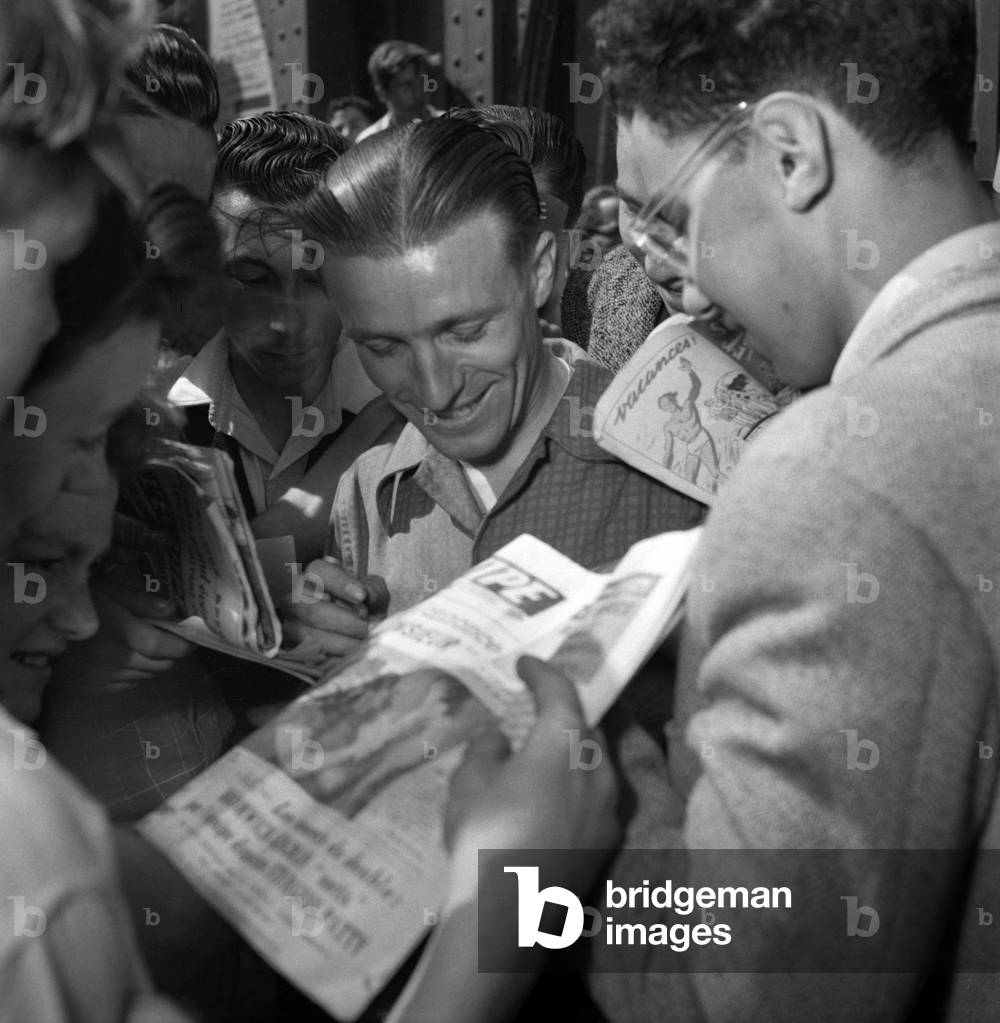 Image Of French Cyclist Georges Ramoulux Signing Autographs Before The image-of-french-cyclist-georges-ramoulux-signing-autographs-before-the