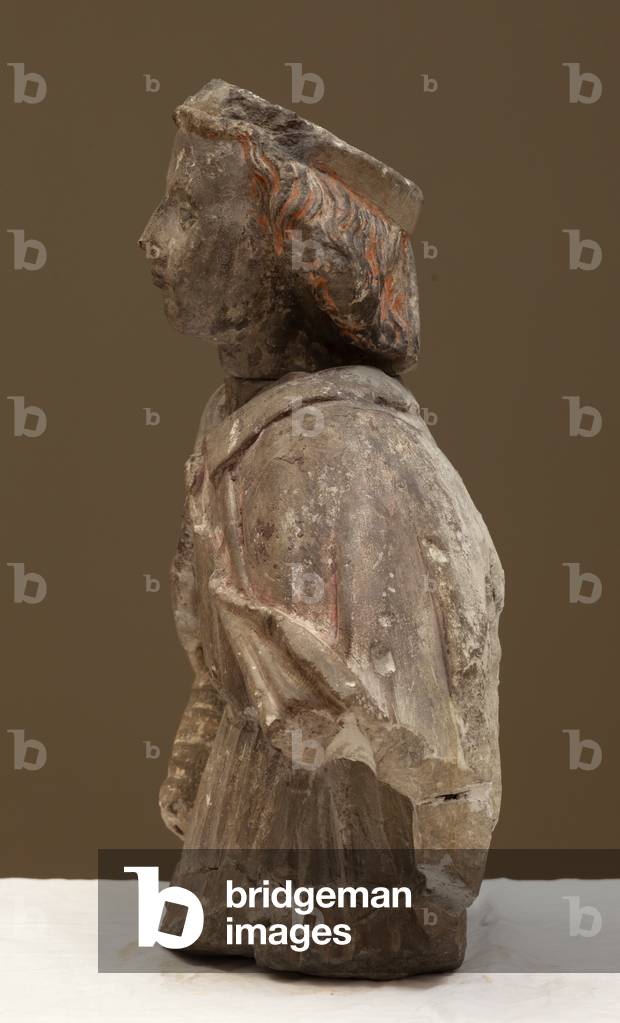 Fragment of a statue, bust. White stone. Rests of polychrome. From the Museum of History and Archeology of Tou