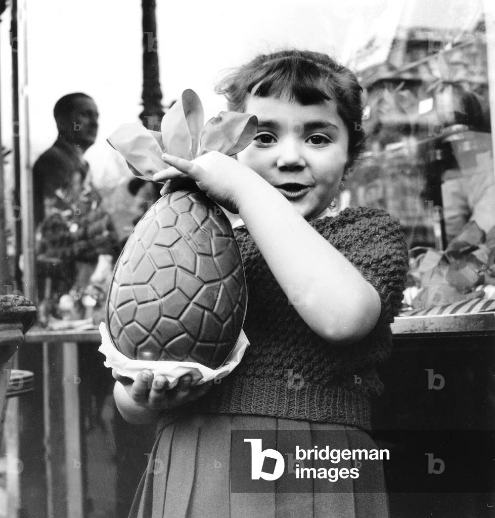 Child with delicacy chocolate eggs for Easter, b/w