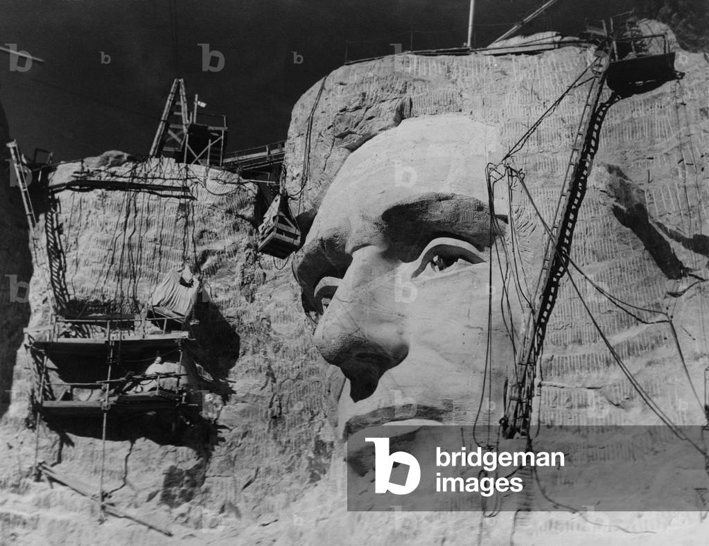 Image of Photography depicting Face of Abraham Lincoln under construction on Mount Rushmore, b/w