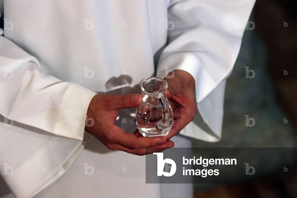 Image of Catholic church during covid19 epidemic. Sunday mass. Altar boy