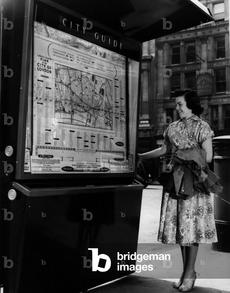 May 05, 1954 - New Seven-Foot High Street Guide To London Unveiled: Alderman G.E. Earlebach, Chairman of the City Streets Committee - this morning performed the ceremony of unveiling the first of fifty - seven foot high” Guides to London” - on the pavement opposite St. Paul's Cathedral. The Guide boards are to be placed at points throughout London - and at the turn of a handle cross reference maps unroll behind unbreakable glass. At the side of the maps are lists of 3,000 shops, business houses etc. and a list of 4,500 streets. The guide is the work of Norwegian Lars Ringdal of Oslo