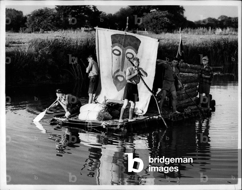 Aug. 13, 1953 - The Kon TiKi boys comes cruising down the Thames.: Old Man River gets an adventuruos crew. Five Bristol Boy Scouts on their home-made replica of the famous Kon Tiki raft are floating on oil drums down the Thames. They started from Lechlade, Gloucestershire, on Sunday. But it's hard work poling - it took them three days to cover 16 miles. They hope to reach Oxford tomorrow. They are seen here at Shifford Lock, Oxfordshire. The trip, including building the raft and its transport to the river, cost? 3 2s, a head.