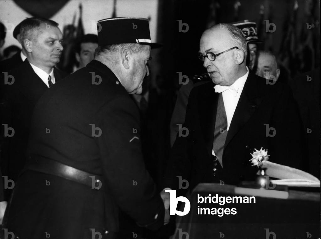 Nov. 11, 1953 - Armistice Day Celebrations in Paris; President Auriol shakes hands wit ha Gaudin, keeper of the Flame of the tomb of the unknown soldier ever since it has been burning (30 years)