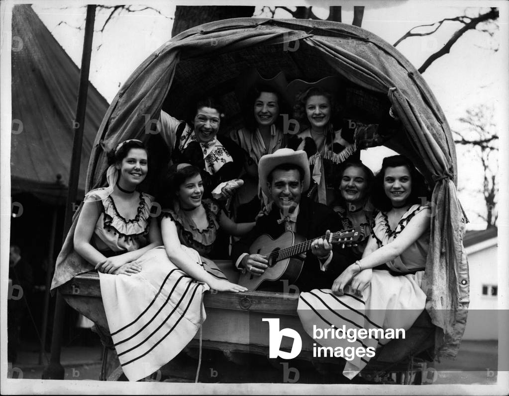 Apr. 04, 1953 - Chuck Wagon Party at the festival Gardens:” Tennessee Ernie” - American's popular Western Hill Billy star held's Chuck-wagon party at the Better-Sea Pleasure Gardens yesterday. Picture Shows: Tennessee Erine in the Chuck wagoh with the” Gates-wingers” and the Gowgirls.