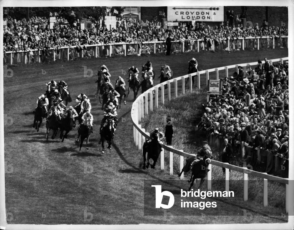 Jun. 06, 1953 - 6.6.53 Gordon Richards win his first derby. Queen's horse, second - “”, with the Queen's horse “” Aureole””” ridden by W. Carr, second and “” Pink Horse”” (Rae Johnsotne), third. Keystone Photo Shows: The scene as the Derby field rounds Tattenham Corner, during the race today.