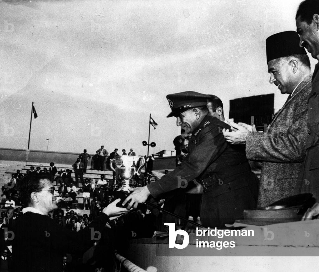 Tue 03, 1953 - Drobny Beats Von Cramm In Final Egyptian Lawn Tennis Championship. Neguib Presents The Cup: J. Drobny (Egypt) beat Baron Von Cramm (Germany) by 6-4; 6-1 - 6-1. in the final of the Men's Singles of the Egyptian Lawn Tennis Championships in Cairo