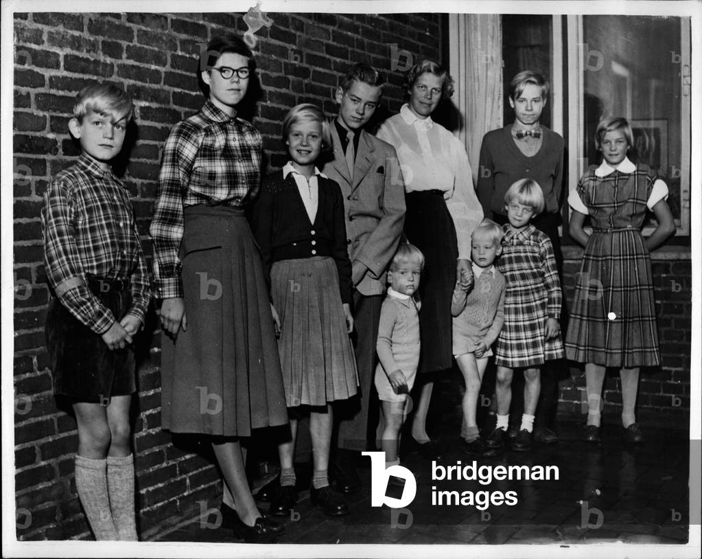 Oct. 10, 1953 - Danish Mother Of Nine Appointed Trade Minister. New Socialist Cabinet.: Mrs. Lis Groes who has been appointed Minister of Trade in the new Daniah Cabinet - is the mother of nine children. Her family were none too haapy when the appointment was made - for they said that she will have less time than ever to attend to them. They prepared their own sign - which is Danish reads” The Place for a Women is in her Home” - and fixed it outside their front door