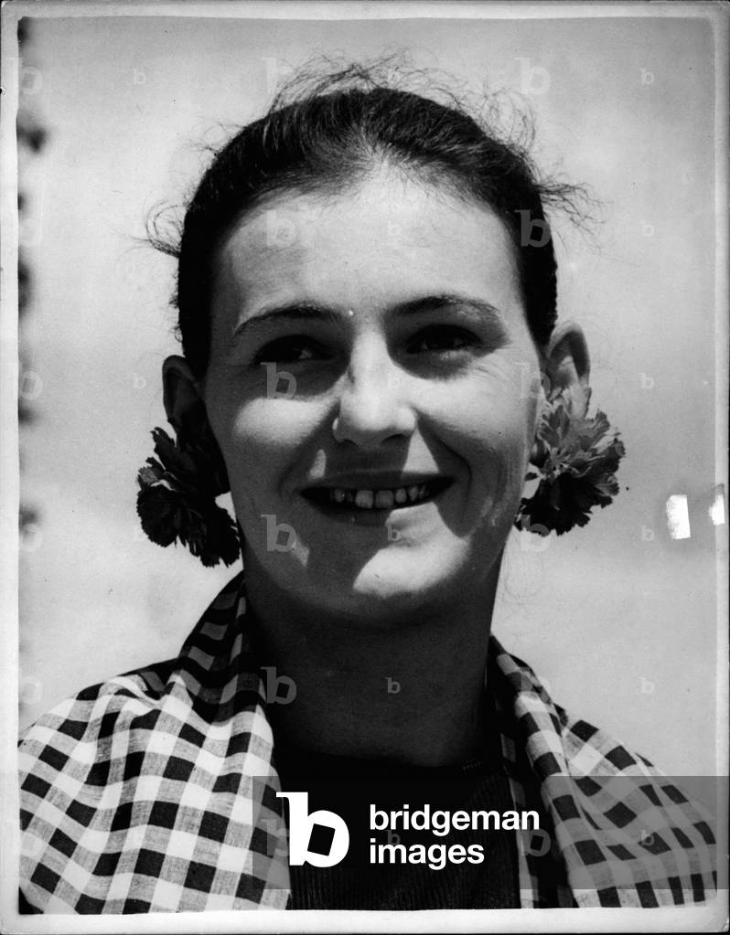 Jun 06, 1953 - Opening Day at Wimbledon Keystone Photo Shows: 19 year old Miss Jean Cameron, of Ealing, arriving at Wimbledon today wearing artificial red carnations in her ears - and a black and white gingham dress which she made herself.