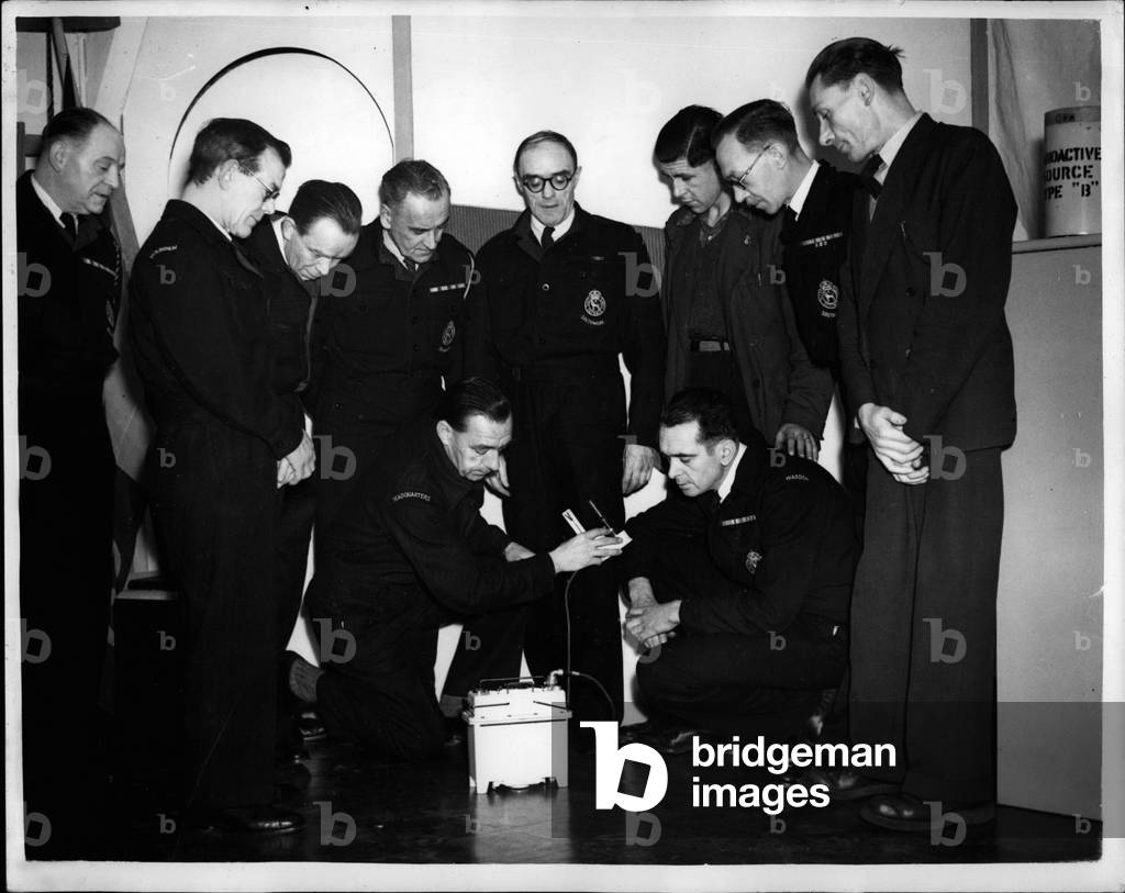 Jan. 01, 1954 - London's Atom Fortress Is Ready Vital Centre Prepared For Emergency - In Southwark: The new Atom Bomb Proof fortress one of 100 'atomic' C.D. headquarters in London is now ready for use in Southwark. AT least a thousand tons of earth has to be moved for pumps for the construction of the centre. A diesel generator pumps filtered air into an “operations room” and provides emergency heat and light. Nothing should budge the control center which has an area below ground level of over 2,000 square feet with its own telephone exchange, mass facilities; toilets and rest rooms for weary rescue teams. The fortress has been equipped with a recreation centre. In changer is Mr. Hugh Pierce who has moved into new prefab offices and training center built on top of the underground centre - and in case of emergency the teams move below to continue emergency operations unhampered