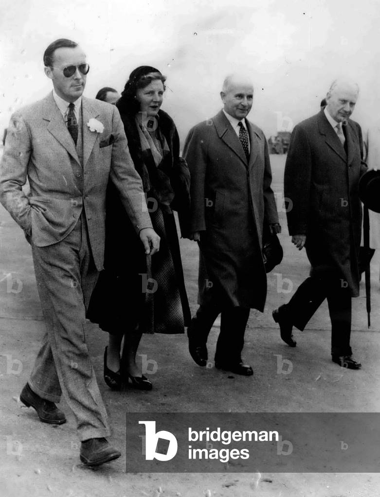 Oct. 10, 1953 - Queen Juliana in Paris; Queen Juliana of the Netherlands, seen with Prince Bernard (left), seen leaving Orly Airport, after arriving in Paris by air yesterday.
