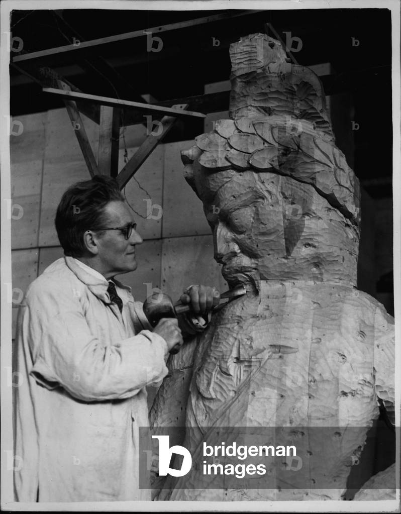 sculptor David Evans working on two pieces of reborn London history (b/w photo)