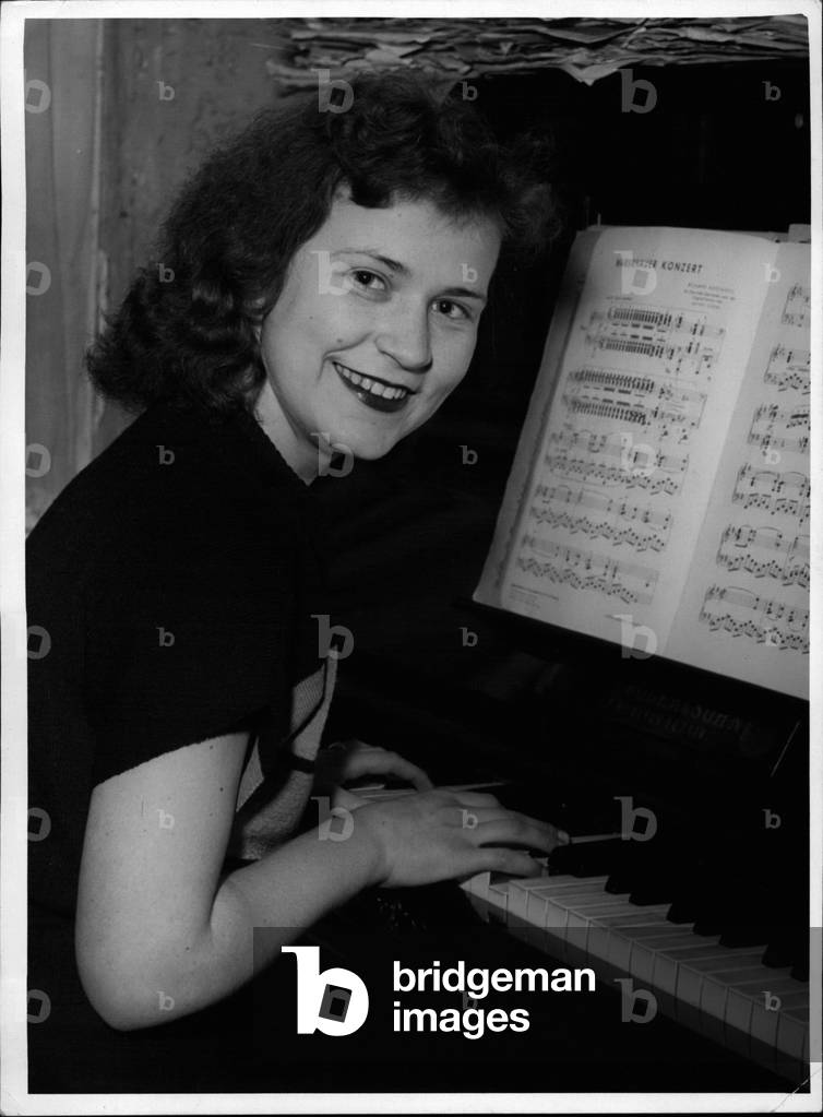 Tue. 11, 1953 -” It's like a fairy tale... I still don't quite believe it.” Pictured is 16 year old pianist Christa Schwarz, from Berlin. She informed reporters that she would be going on a grand tour through America the next month. She had only answered a newspaper ad requested a pianist out of fun. 71 year old tenor Carl Neumann, discovered and trained by American soldiers, was so enthused by her playing he immediately hired her. Now this duo of the youngest and oldest musical team will be on tour, which should last four to five years.