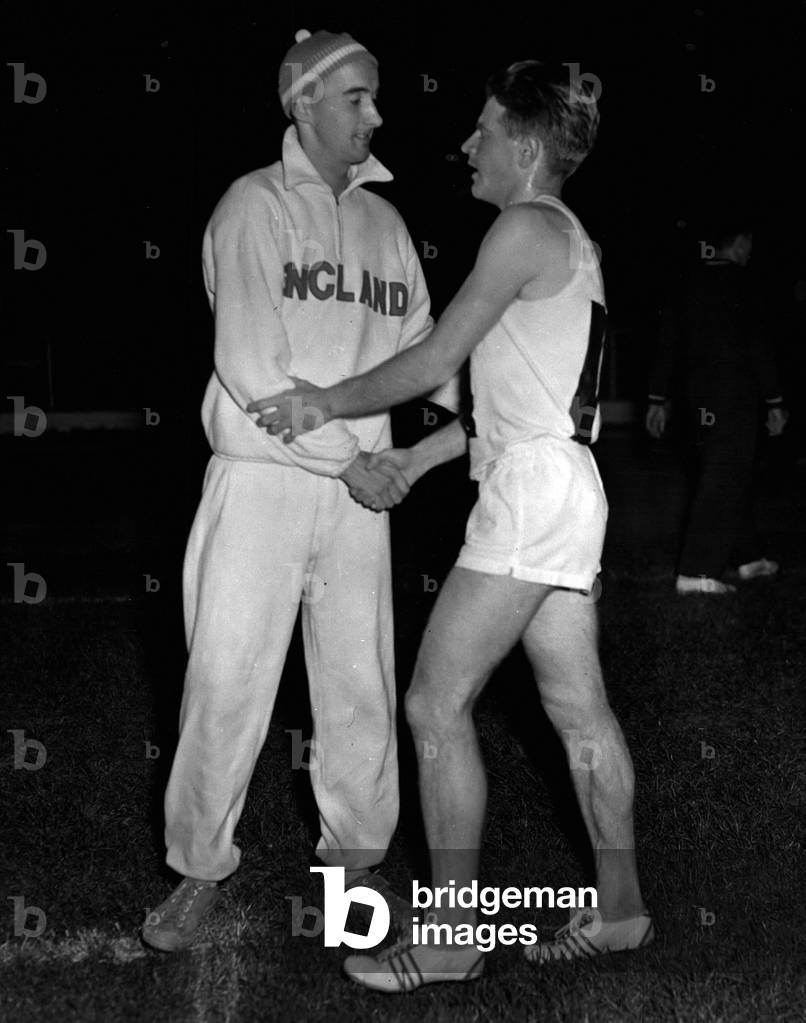 Oct. 10, 1954 - Chataway Beats Kuts in 5,000 Meters race at the White City Britain's Chris Chataway last night won a great 5,000 meter race against Vladimir Kuts, the Russian world and European record-holder, in a match between London and Moscow at the White City. He won by little more than a yard, and, to the delight of the 40,000 spectators, he beat the world record by 5 seconds. Britain Gordon Pirie (left) who won the two-mile Invitation race, congratulating Chris Chataway after his great win over Kuts