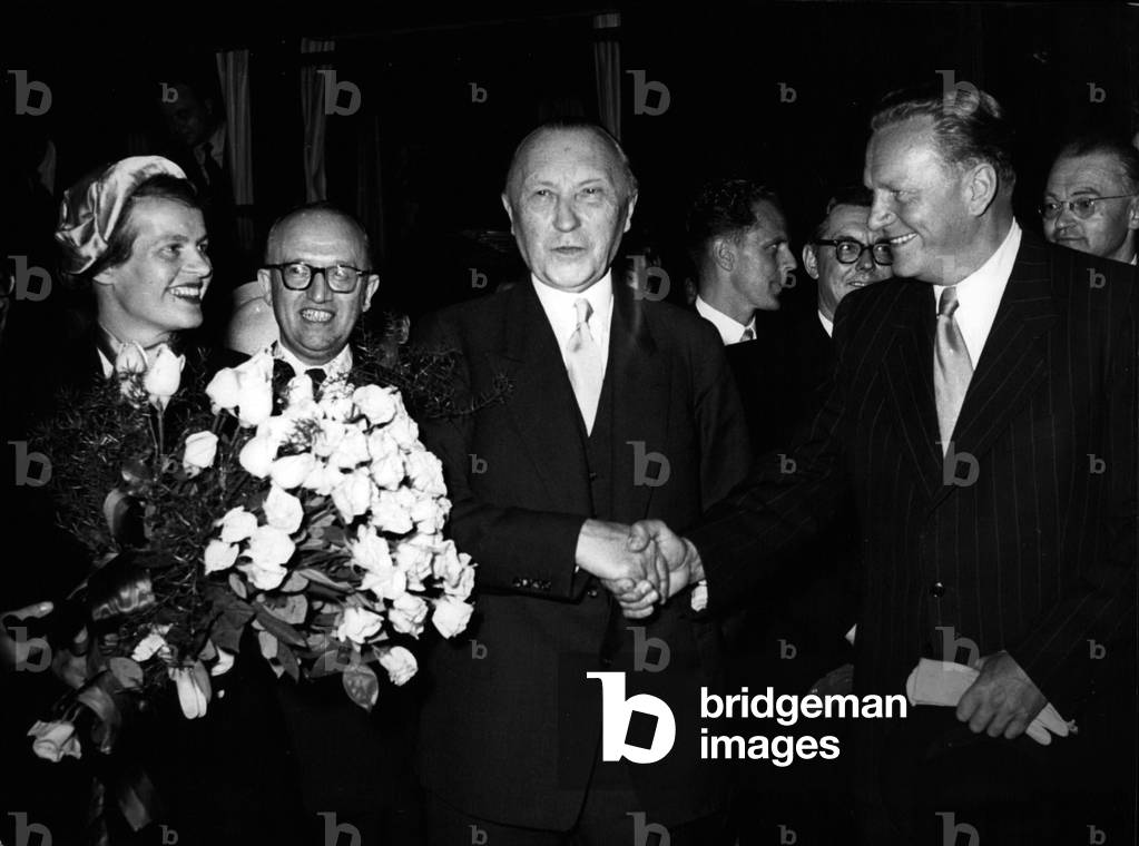May 19, 1953 - Austrian Secretary of State Gruber arrived in Germany for a severe-day visit. He was greeted at the station by Chancellor Dr. Adenauer. Pictured: Mrs. Gruber, Dr. Adenauer, and Dr. Gruber.