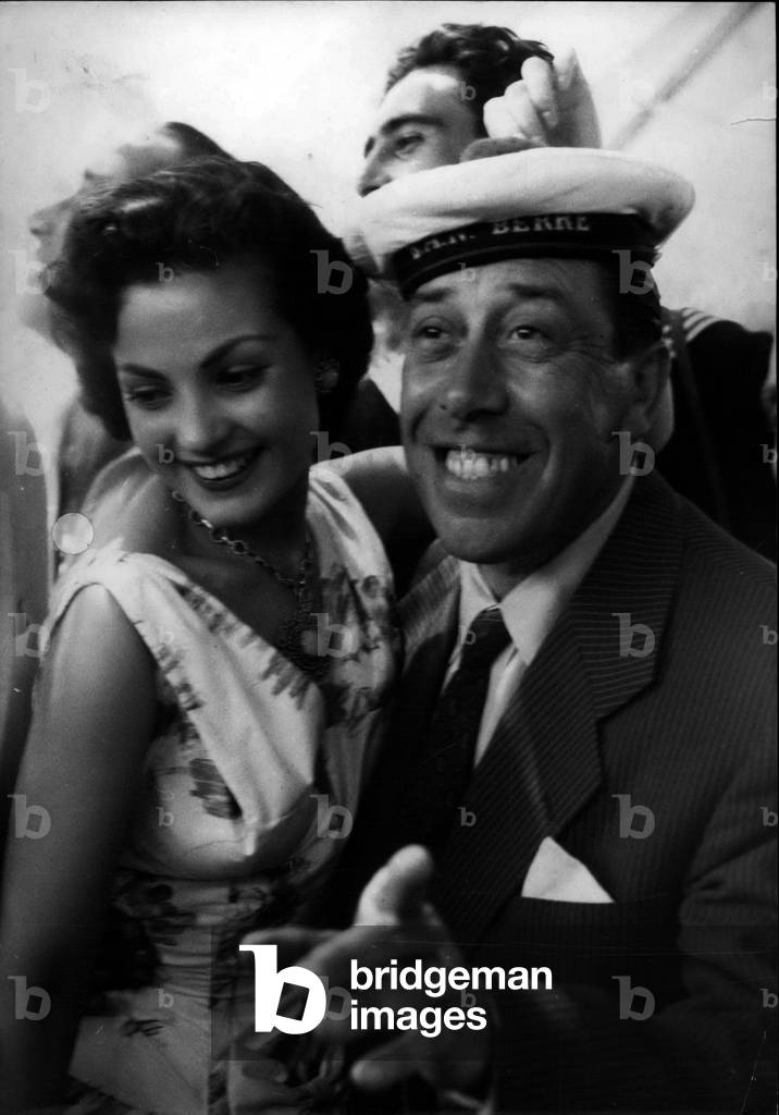 May 08, 1956 - Fernandel (Fernand Joseph Desire Contandin, 1903-1971) and Carmen Sevilla (nee 1930) at a Cocktail Party