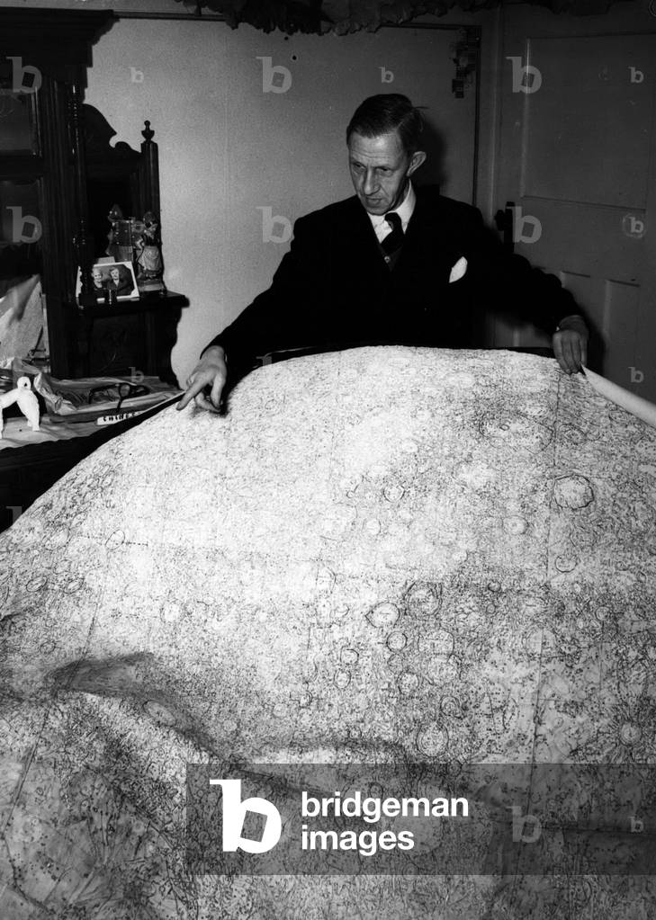 Dec. 12, 1953 - Giant Bridge seen on the moon. Discovery by astronomer.: Astronomers have spotted a huge bridge on the moon which looks like an engineering job”. Dr. H. Percy Wilkins, Fellow of the Royal Astronomical Society, said on the B.B2 ~'s radio newsreel last night that the bridge is 20 miles long and 5,000 feet high, and snaps a gulf between mountain ranges 6,000 ft. and 10,000 feet high. But there do not appear to be men on the moon after all.” The bridge, is, of course, not man made” - said Dr. Wilkins after the broadcast.” Though the span is 20 miles the arch is probably only two miles across” The explanation?” A mete ~ ~ ite might have crashed through a molten-lava barrier and as the barrier solidified an arch was left” he said