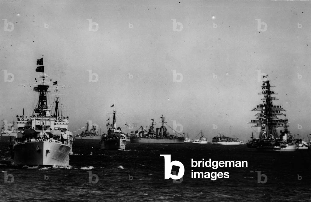 Jun. 06, 1953 - Royal Review of the fleet: Portsmouth: The Despatch vessel Surprise acting as Royal Yacht - seen passing a long the lines of ships during the Coronation Review of the Fleet by Her Majesty the Queen, at Spithead. The picture was made from the Trinity House ship Patricia, which sailed in procession with the Royal Yacht. On the right can be seen the Italian vessel Amerigo Vespucci, with her crew manning the yards. The Italian ship, a training vessel, is one of the number of foreign ships at Spithead for the Review.
