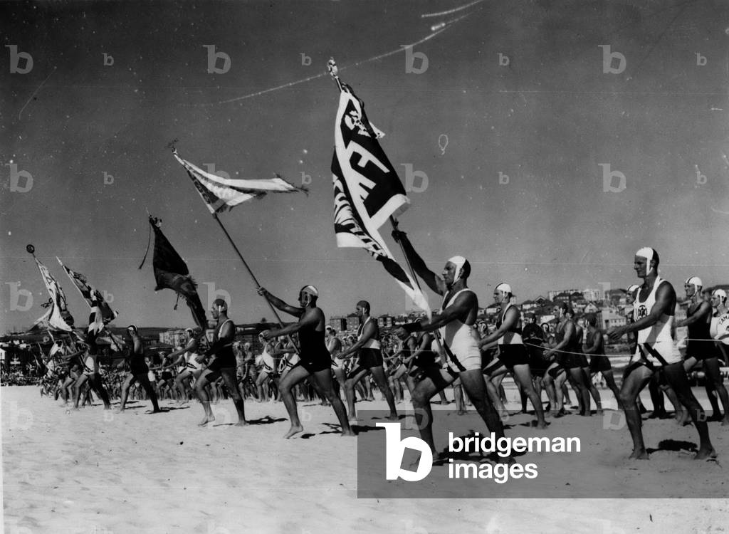 Feb. 11, 1954 - Royal Australian Tour - Original Picture Queen sees life Savers at Bondi Beach. The highlight of the Royal visit to Bondi Beach, Australia, was the surf carnival, in Which the Queen and her husband, sitting amid a vast concourse of people in summer cloths, were so interested the they overstayed their time. This pictures shows the parade of Surf Life Savers marching up to the Queen's dais
