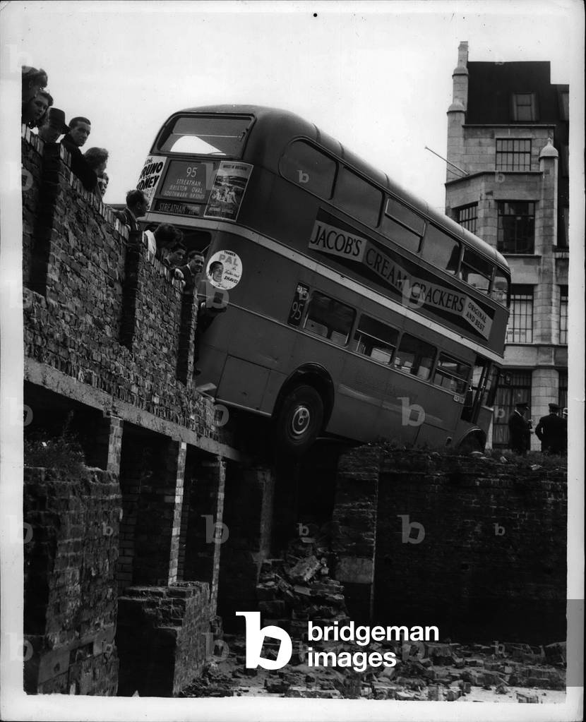 Sep. 09, 1953 - The Bus That Cut a Corner. One minute this bus was on the road bound for yesterday's rush-hour crowds at Cannon-street station. The next minute is balanced across the corner of a 10-ft deep bomb site in Upper Thams-street. No one was injured.