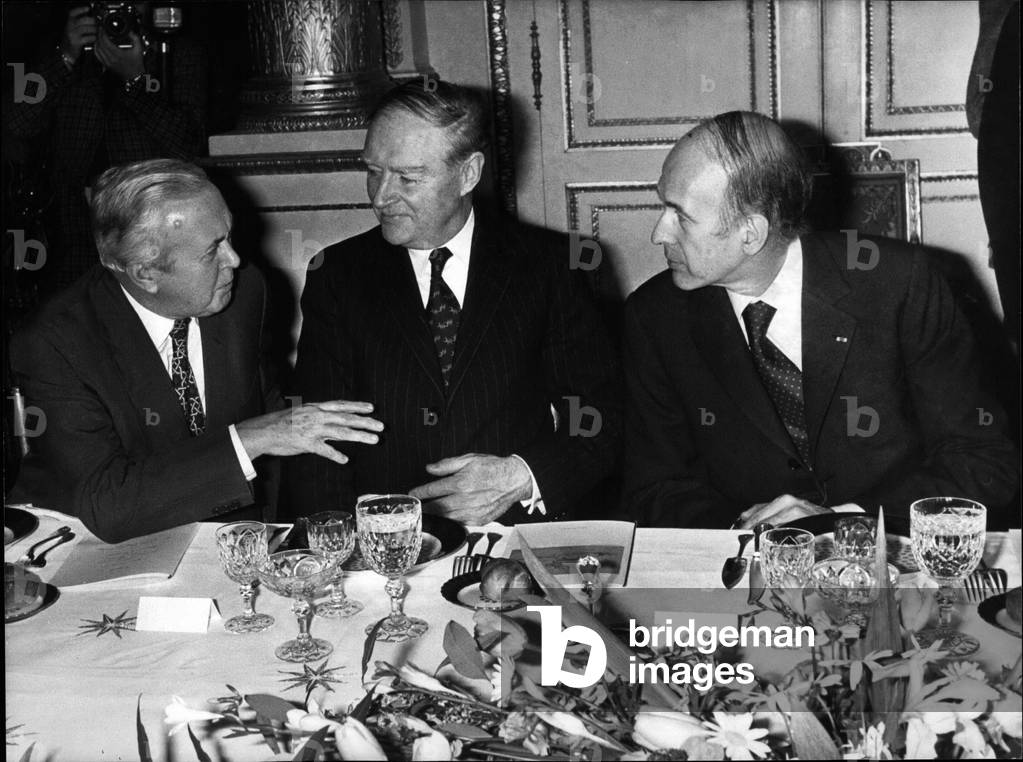 Dec. 10, 1974 - British Prime Minister Harold Wilson, Taoiseach of Ireland Liam Cosgrave, and French President Valery Giscard d'Estaing talking over dinner at the Elysee Palace