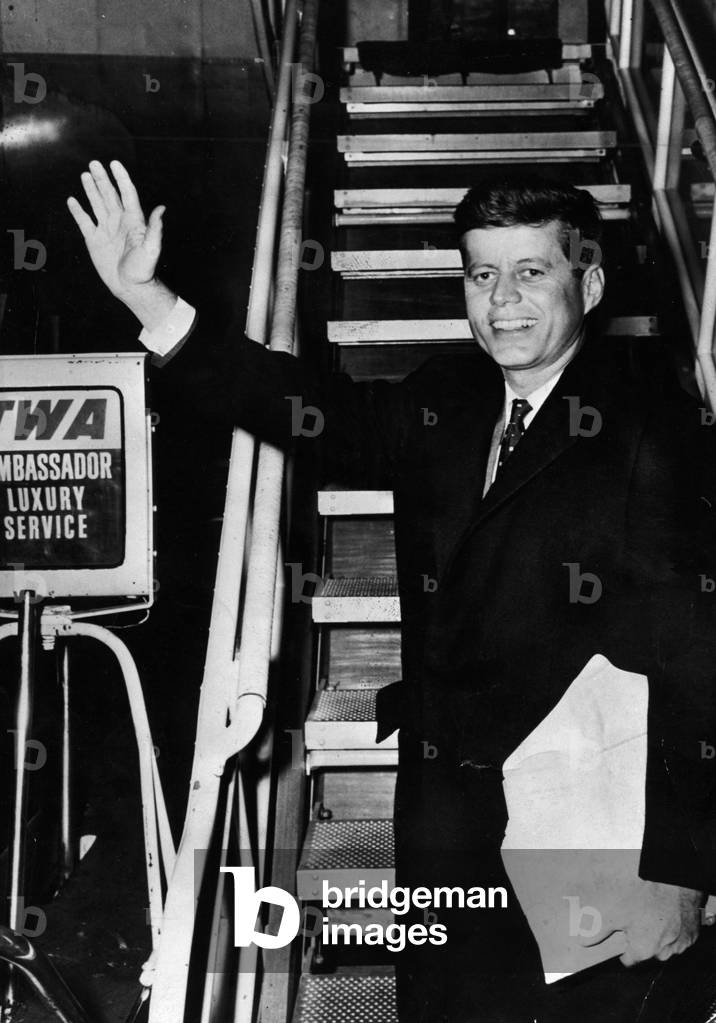 Dec. 1, 1959 - Washington D.C., U.S. - President John F. Kennedy waves as he boards a plane.