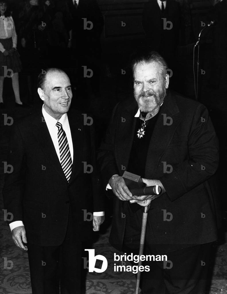 French President Francois Mitterrand (1916-1996) presents the Legion d'Honneur to Orson Welles (1915-1985) 198