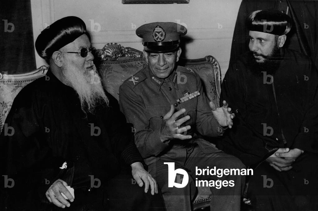 Apr. 04, 1953 - GENERAL MEGUIB VISITS PATRACHIS. The Egyptian Prime Minister, GENERAL NEGUIS, made personal visits during the Easter celebrations in Cario to the Coptia Catholic and the Caption Orthodox Patriarch, and the Egyptian Protest Church, to tender his Eanter Wishes. KEYSTONE PHOTO SHOWS: - GENERAL NEGUTS seen talking with the Coptle Orthodox Patriarch (left) in Ceiro.