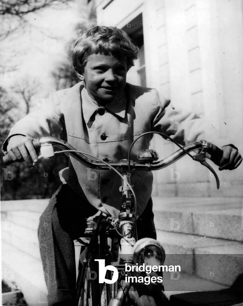 Apr. 26, 1954 - Crown Prince Carl Gustaf of Sweden Celebrates his eighth birthday.: Crown Prince Carl Gustaff of Sweden - the son of Princess Sibylla and the late Prince Gustaf Adolf - celebrates his eight birthday on April 30th. This picture shows the young Prince riding his cycle presented to him for a Christmas gift by his grand father King Gustaf Adolf. The picture was taken at Haga Castle - specially in honor of his birthday