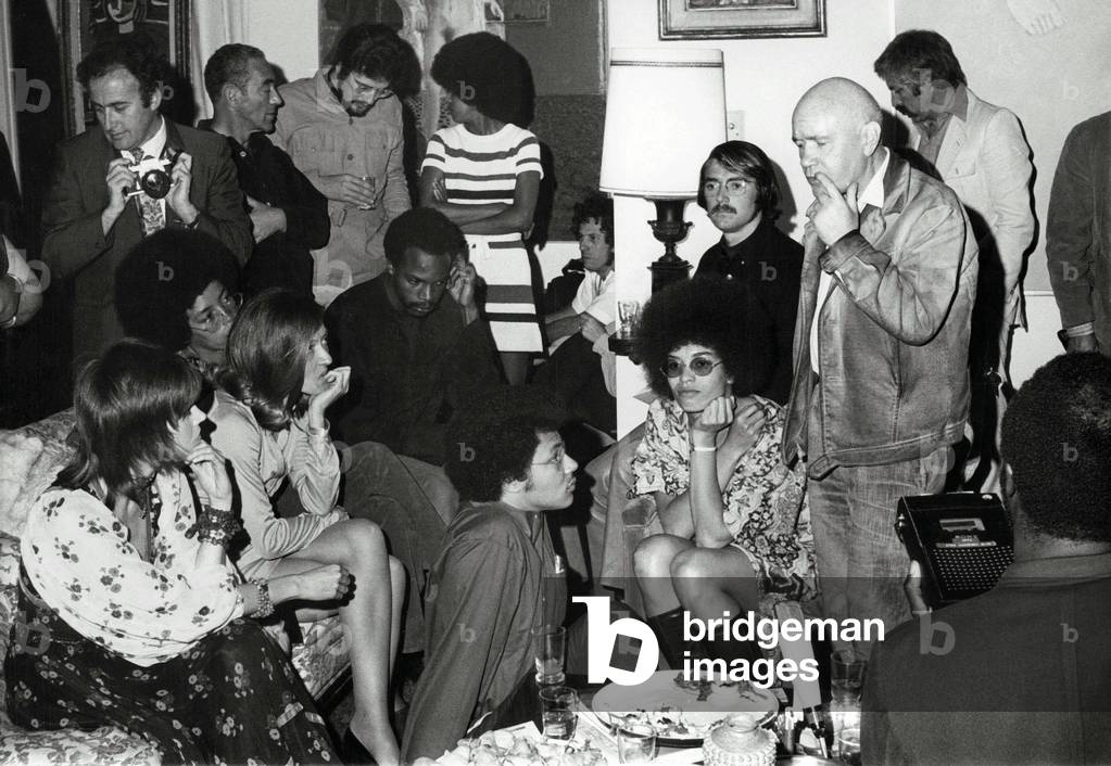 Portrait of Jean Genet (bald), Jane Fonda (left) and Angela Davis (sitting with glasses) of the Black Panthers