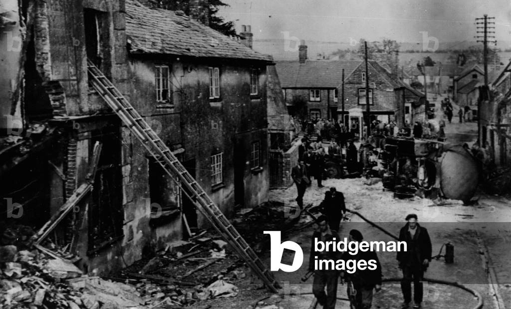 Apr. 04, 1953 - Twelve-wheeled oil tanker crashes in village street driver killed: A huge twelve-wheeled oil tanker lorry crashed down the main street of Lambourn, Berks, yesterday-ripping into the corner well of the village sweet shop tearing down on empty 14th. Century cottage next door- and into a jeweller's and antique dealers shop-ending up in the gutter and spraying showers of petrol over the road. The accident happened when the drive Reg Bungay lost control of teh vehicle as it tore down the hill to the village.. He stayed at the wheel in an attempt to avert disaster- and lost his life in the crash..