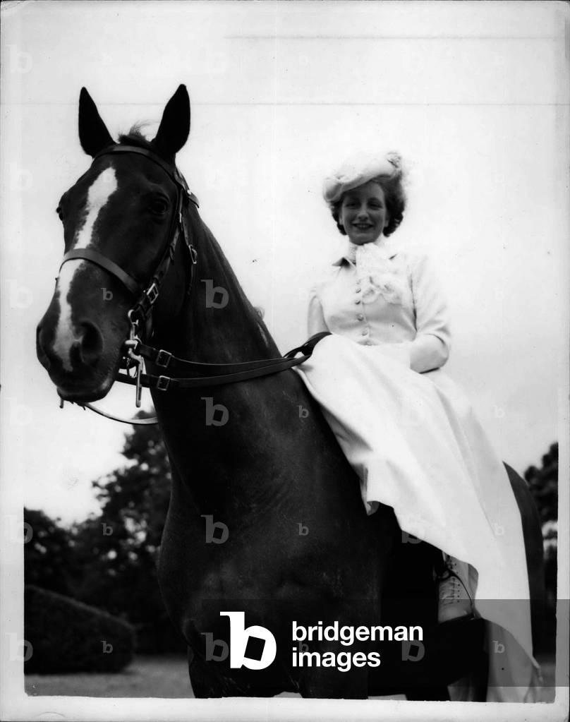 Jul 06, 1953 - Rehearsal for coronation searchlight tattoo. Woman police constable to take part.: An attractive young London Policewoman is to take part in the Coronation Searchlight Tattoo, which opens at the White City on July 13th, and which the Queen will wait on the 14th. She is Woman Police Constable Cynthia Berg~nt.One of the highlights of the Tattoo will be a Cavelry Ride by the Metropolitan Mounted Police, wearing the full dress of famous Cavalry regiments. A feature of the Ride is the Bridal Arch, when the troopers form an archway with their lances. Under the archway of lances, accompanied by a trooper, Woman Police Constable Inkster will ride in a special-made, all-white costume, a form of bridal gown. Rehearsals were held today at Imber Court