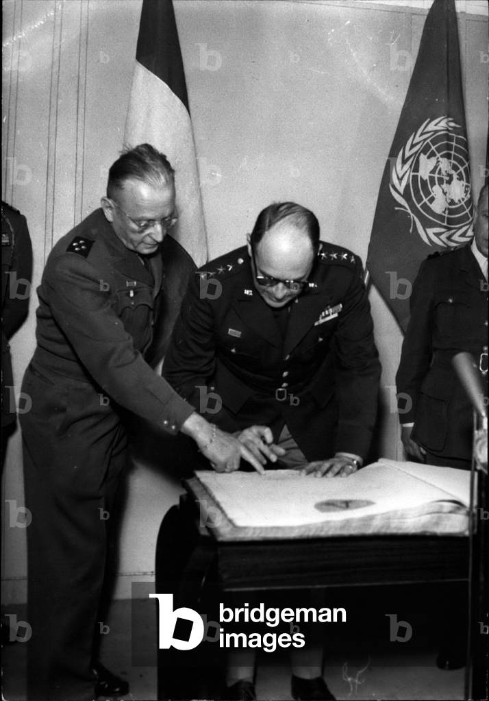 Korean Batallion Honoured: General Matthew B. Ridgway sings the Golden book of the French Korean batallion during the ceremony held at shape today Tue. 03, 1953 (b/w photo)