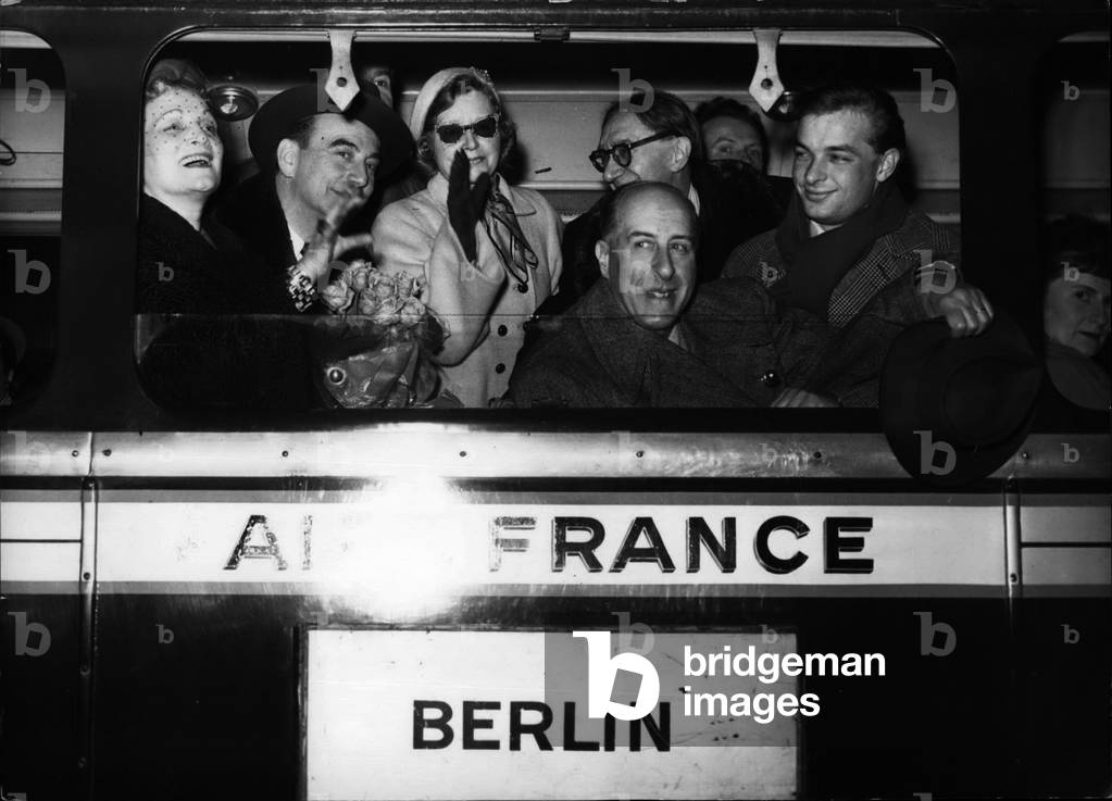 Apr. 04, 1954 - Off to Moscow: Actors of the Comedie Francaise who are to play in Moscow photographed in an air France Motor Coach leaving for Orly airfield. They are from L to R (First row) Germaine Rouer, Maurice Escande, Marie Sabouret, Raoul Henri and Roussillon. Part of the famous company are already in Moscow waiting for the remainder of the troop to join them