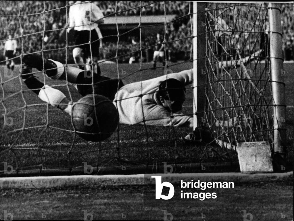 May 05, 1954 - Football-play England - Hungarian: the last weekend the British football-team lost against the Hungarian team 7:1 (3:0). Picture Shows in vain the British goal-keeper (Herrick) jumped for ball shot by the Hungarian Hidegkuti as the 6th goal