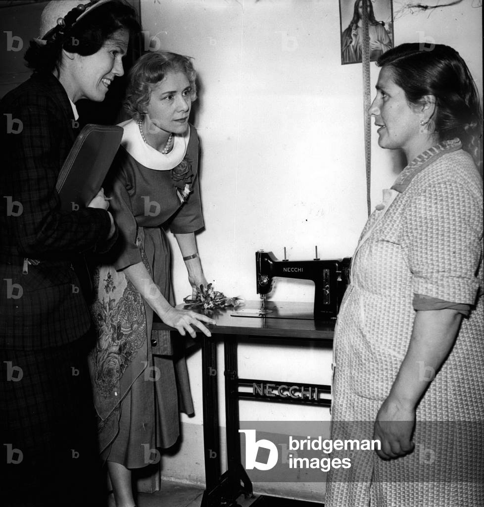 May 05, 1953 - 1/6 ambassador talks to local woman (right) about her sewing machine