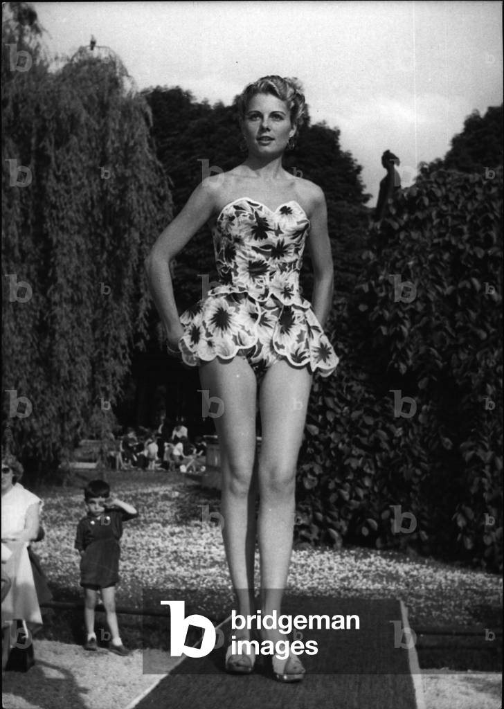 May 05, 1953 - Paris Mannequins model beach fashion. one of the bathing costumes displayed by a Paris mannequin at Le Doyen's, the fashionable champs - Elysee restaurant, Paris, today.